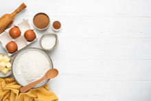 Ingredients For Baking A Cake Cookies Or Sweet Pastry On White Wooden Table Background