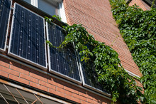 Close-up Of Solar Panels On A Red Brick Wall. Alternative Energy Source. Caring For The Environment.