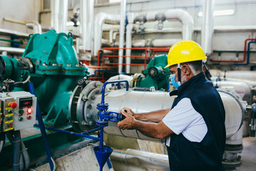 Wall Mural - worker in protective equipment working indoor in industry plant, covid protected with mask