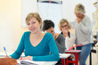 © auremar - portrait of young adult sat at desk in classroom