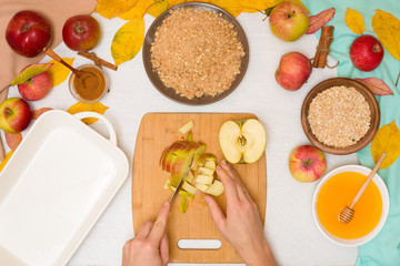 Wall Mural - Apple crisp crumble, step-by-step recipe and mixing ingredients for home cooking on a light background top view. traditional autumn dessert with cinnamon and oatmeal, honey. cutting apples