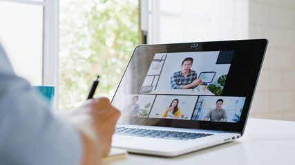 Wall Mural - Asian man video call conference, online remote meeting with business coworker, at home. New normal lifestyle, social distancing, internet technology, businessman work from home concept