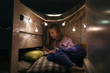 © Javier Pardina/Stocksy - Kid playing in her tiny home, inside the room.