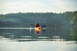© Serhii Prystupa - The guy is kayaking on the lake in the fog