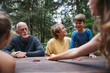 © Rob and Julia Campbell/Stocksy - Fun loving grandparents playing card games with grandkids on cam