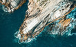 © Akela - from alp to alp/Stocksy - rock and ocean from above
