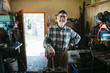 © Rob and Julia Campbell/Stocksy - Portrait of older blacksmith looking at camera