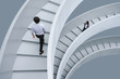 © MaaHoo Studio/Stocksy - Businessman and businesswoman walking on office stairs