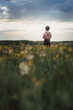 © Amir Kaljikoviƒá Photography/Stocksy - Low angle view of a young boy in a country field