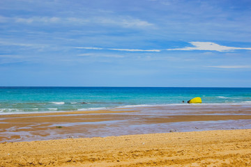 Turquoise sea with tropical beach. Coastline of the ocean, rocks and sand. Sea line from France on the beach. Leisure activities in heavenly resorts, travel concept, lifestyle.