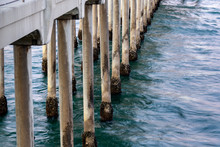 Barnacles Grow At The Waterline On The Concrete Pilings Of The Huntington Beach Pier At Sunset, A Popular Landmark With Tourists And Residents Alike, Even During The Pandemic.