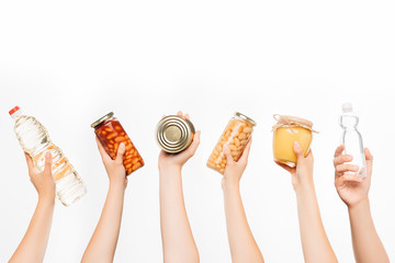 Wall Mural - cropped view of woman hands with food isolated on white, charity concept