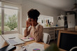 © StratfordProductions - Young stressed woman holding hands on head while sitting in front computer laptop