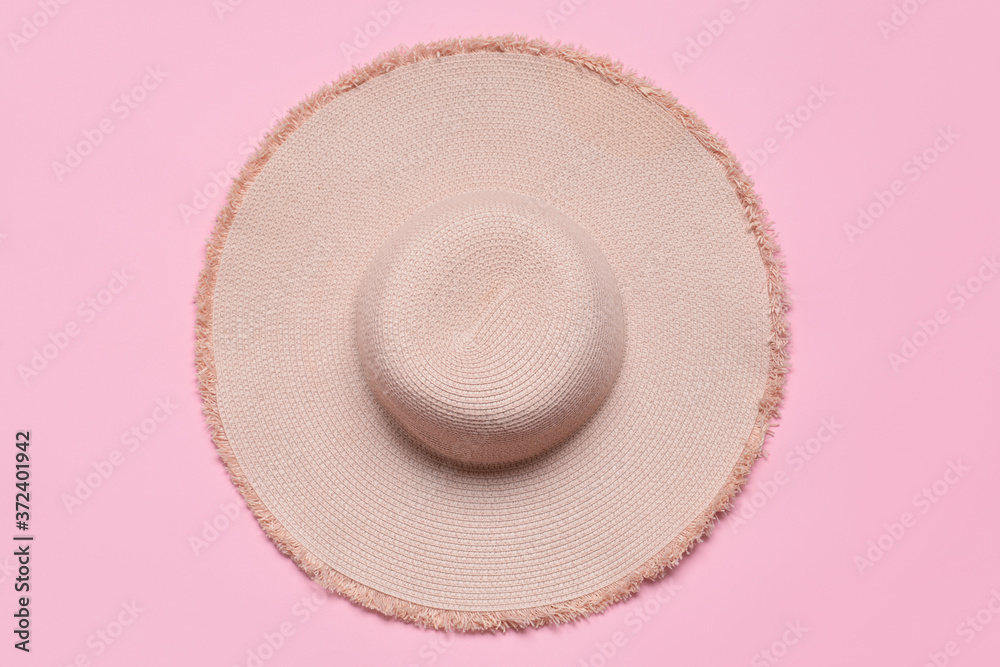 Straw hat on color background