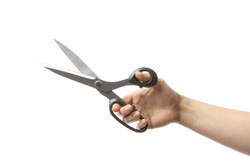 Female hand with tailor's scissors on white background