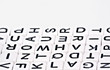 © Lubo Ivanko - Small white cube beads with various letters arranged next to each other, closeup detail