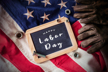 Wall Mural - American National Holiday. US Flags with American stars, stripes and national colors. Construction and manufacturing tools on wooden background. Labor day background concept.