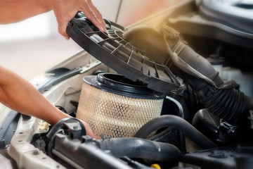 Car mechanic working in repair garage. maintenance checking air filter