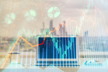 Stock market graph and table with computer background. Double exposure. Concept of financial analysis.