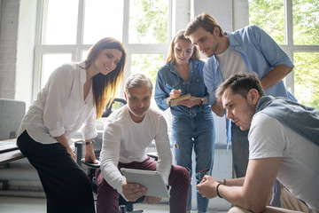 Young professional team. Group of young modern people in smart casual wear having a brainstorm meeting in the creative office