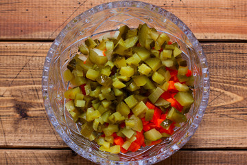 Step by step cooking Olivier salad with beef, step 2 - adding chopped pickled cucumbers, top view, selective focus