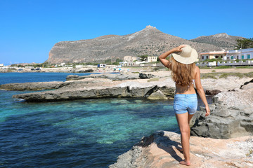 Wall Mural - Beautiful traveler girl in Sicily. Young woman enjoying holidays in Favignana Island in Italy.