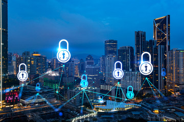 Glowing Padlock hologram, night panoramic city view of Kuala Lumpur, Malaysia, Asia. The concept of cyber security to protect KL companies. Double exposure.