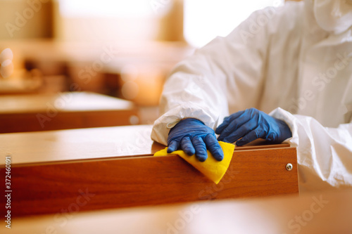 Fotografía Hand in gloves are cleaning school class to prevent COVID-19