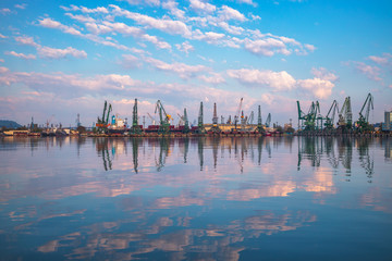 Wall Mural - Sea port and industrial cranes. Sunrise over the Varna lake and Black sea coast