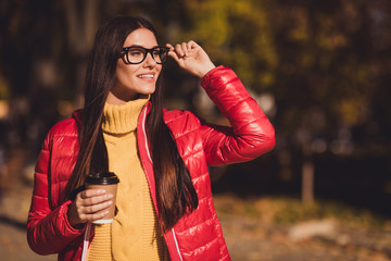 Wall Mural - Profile side photo of positive cheerful girl wait friend weekend october free time promenade look copyspace drink latte cup wear red outerwear