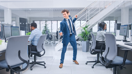 Aufkleber - Young Cheerful Handsome Business Manager Wearing a Suit and Tie Dancing in the Office. Diverse and Motivated Business People Work on Computers in Modern Open Office.