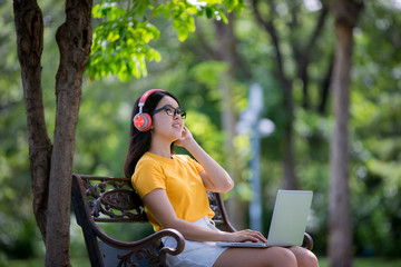 Business women relax and work in the park on vacation
