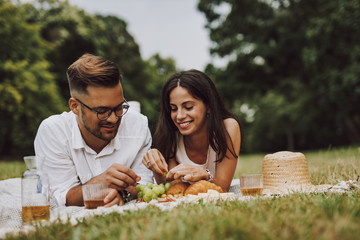 Wall Mural - Young couple sitting in the park.