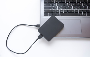 the external hard drive connects to the laptop from above. transferring data from laptop computer to