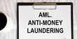 © Veranika - The inscription in the Anti-money laundering- AML notebook, a pen and glasses next to it.