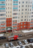 Fototapeta  - Fire engine in the courtyard of a multi-storey residential building in winter.