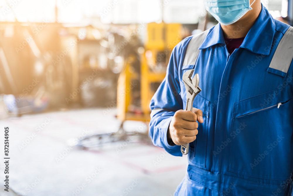 Mechanic Asian man wearing surgical face mask protection fixing ...