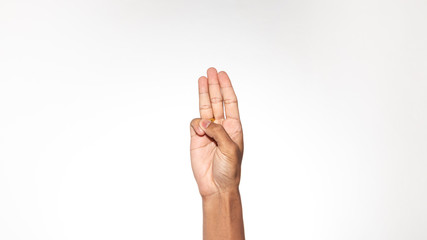 Hand gesturing a three finger salute isolated on white background
