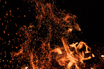 fire flames with sparks on a black background, close-up