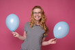 © Viktor Koldunov - Optimistic overjoyed woman with air balloon celebrates her birthday, exclaims happily. Studio shot