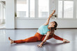 © Daniel Waschnig/Westend61 - Ballerina doing stretching exercises on floor in dance studio
