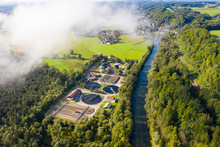 Germany, Bavaria, Wolfratshausen, Drone View Of Countryside Sewage Treatment Plant