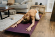 © Sara Monika/Westend61 - Mid adult woman exercising on mat at home