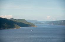 A Sailboat Is Shown On The Saguenay Fjord In The Saguenay Region Of Quebec Canada