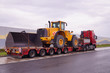 Oversize Load or exceptional convoy (convoi exceptionnel). A truck with a special semi-trailer for transporting oversized loads. Transport of a huge bulldozer.