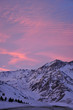 colorful dusk with light clouds and snowy mountains in the foreground