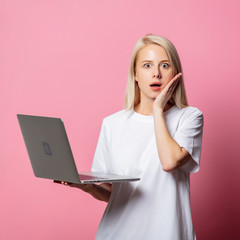 Wall Mural - Blonde woman in white moch-up tshirt and laptop computer