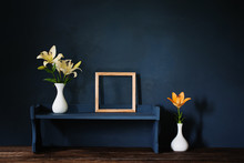 Flowers In Vase And Wooden Frame On Background Dark Wall
