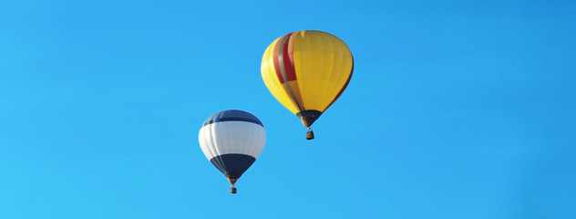 Hot air balloons in blue sky. Banner design