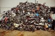 © JAF Stock/ADDICTIVE STOCK - Dump of pile of different old multicolored metal parts for recycling on brown floor near cement wall